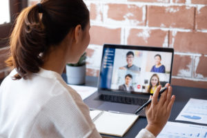woman on video call with co workers