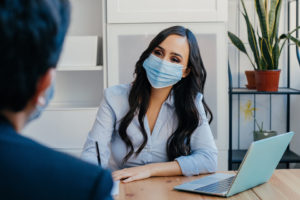 woman and man wearing masks at work